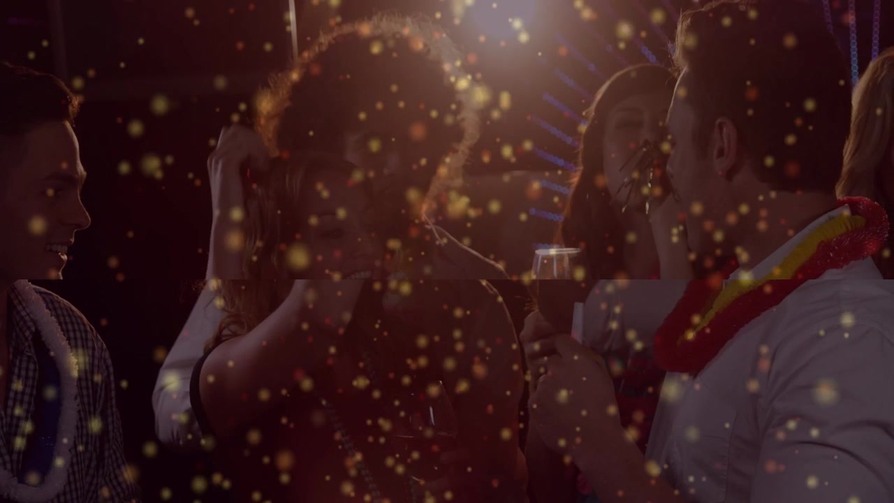 Center woman shifting hair while spotlight hitting group under gold glitter, friends toasting event