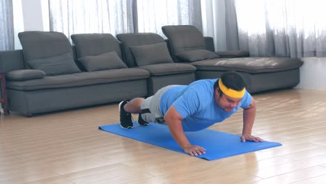 fat man is doing push ups at home