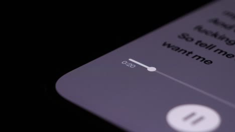 macro shot of timer scroll bar moving as lyrics from song play from spotify app