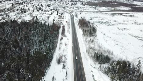 open highway road in the winter of canada - drone 4k aerial