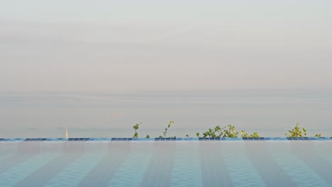 scenic rooftop hotel pool at sunrise looking down across the ocean