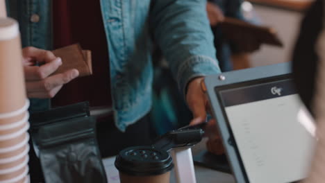 attractive-young-man-paying-using-credit-card-transaction-service-buying-coffee-in-cafe-spending-money-at-restaurant