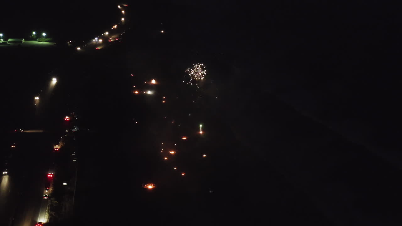 Aerial View of Fireworks and Fires on a Beach at Night