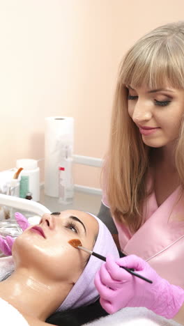 cleansing peeling in the beauty salon. cosmetic treatment of face. aesthetic cosmetology. vertical video