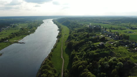 nemunas river and small town of top of slope, high angle drone view