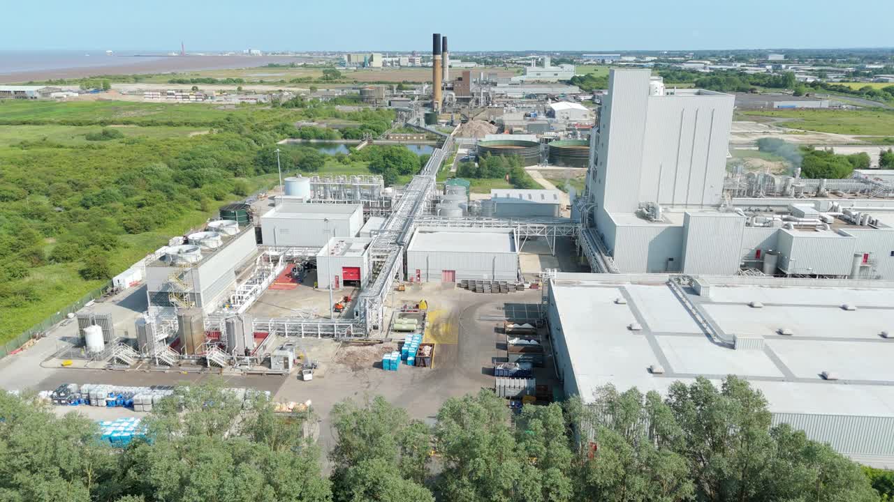 Industrial fibre factory with ventilation fans and chimneys captured by drone in England