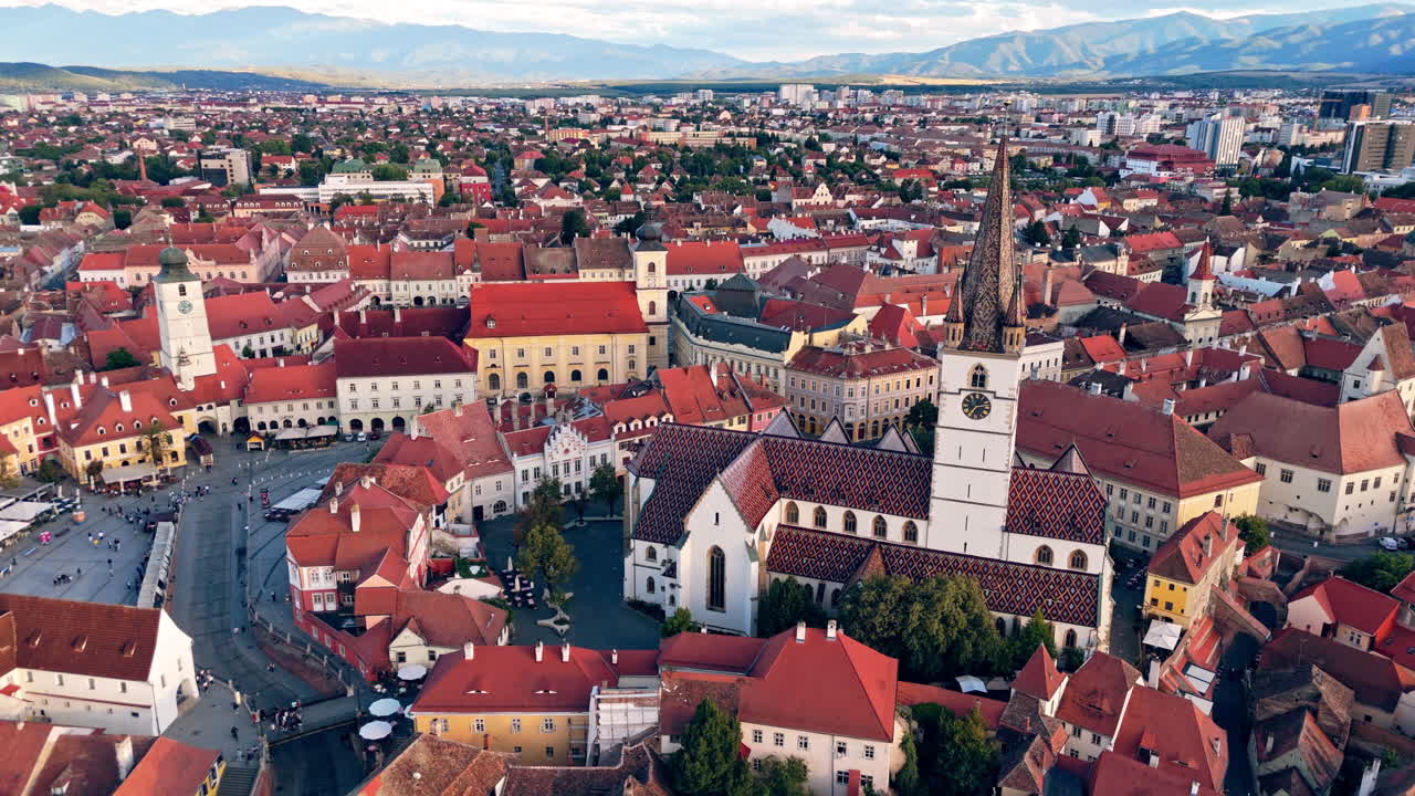 Aerial view of Sibiu's historic center with red roofs and a church