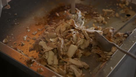 close up shot of chicken shawarma being prepared on grill