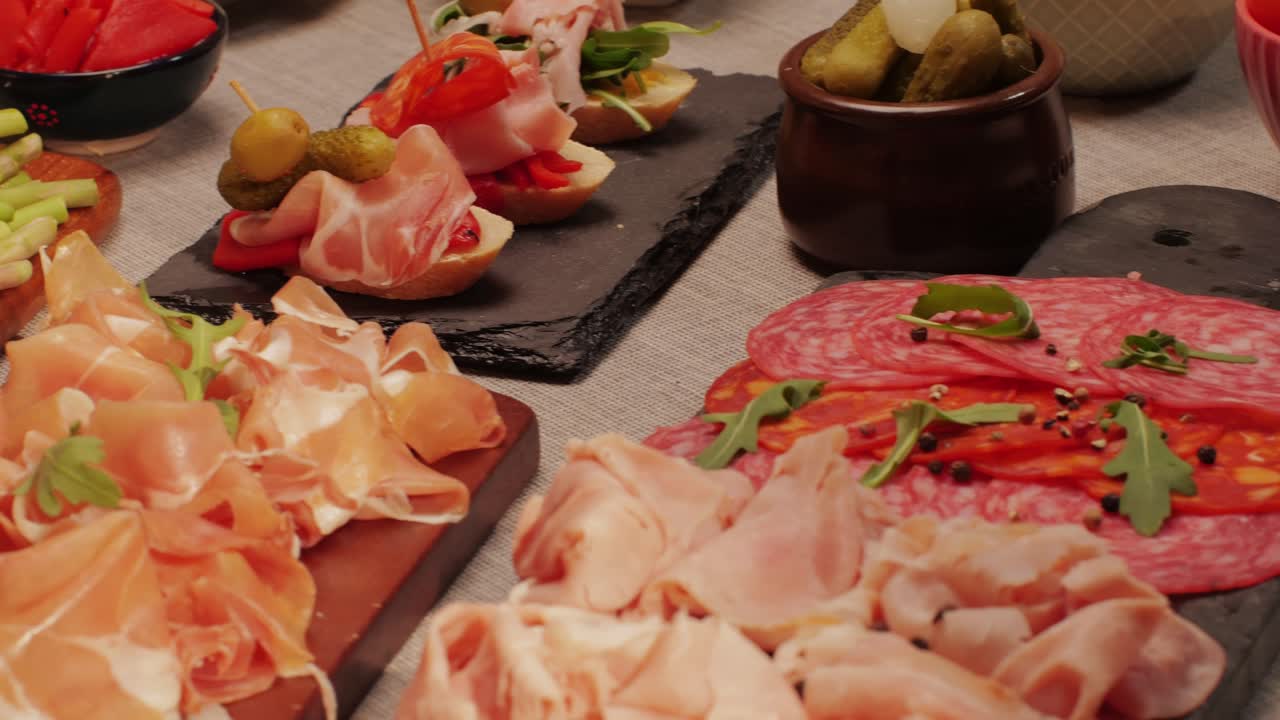 Italian or Spanish restaurant with traditional tapas food, Spanish cuisine, delicious tapas and cheese plate, bruschetta with cheese, olives dry tomatoes and tasty sandwich bar appetizer, buffet