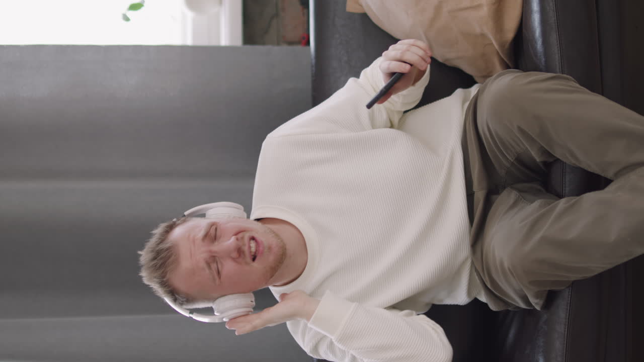 Man in Headphones Enjoying Music and Dancing