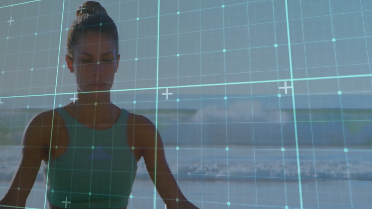 Meditating on beach, woman with digital grid overlay creating animation effect