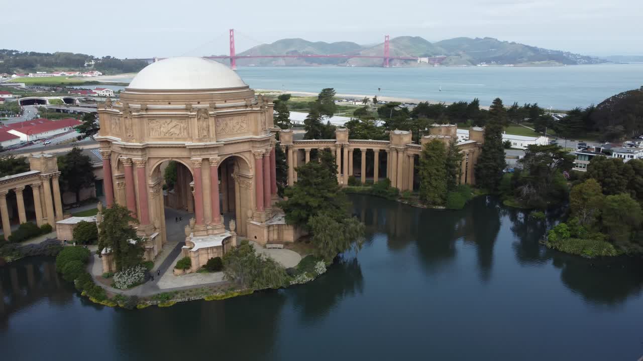 Palace Of Fine Arts In San Francisco, California. Slow Aerial Parallax Revealing The Presidio, Marina, And The Iconic Golden Gate Bridge.