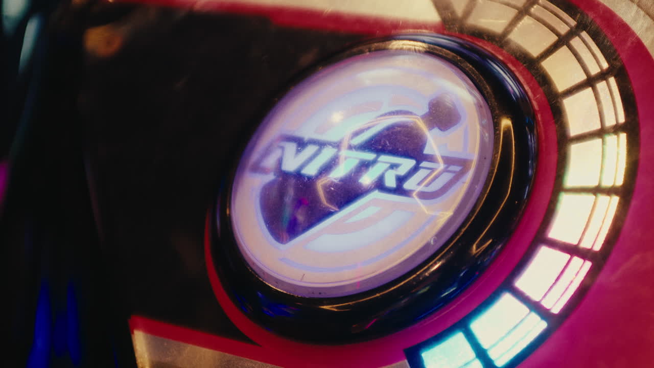 Hand pressing nitro button dropping nitrogen explosive starting a war in arcade video games room