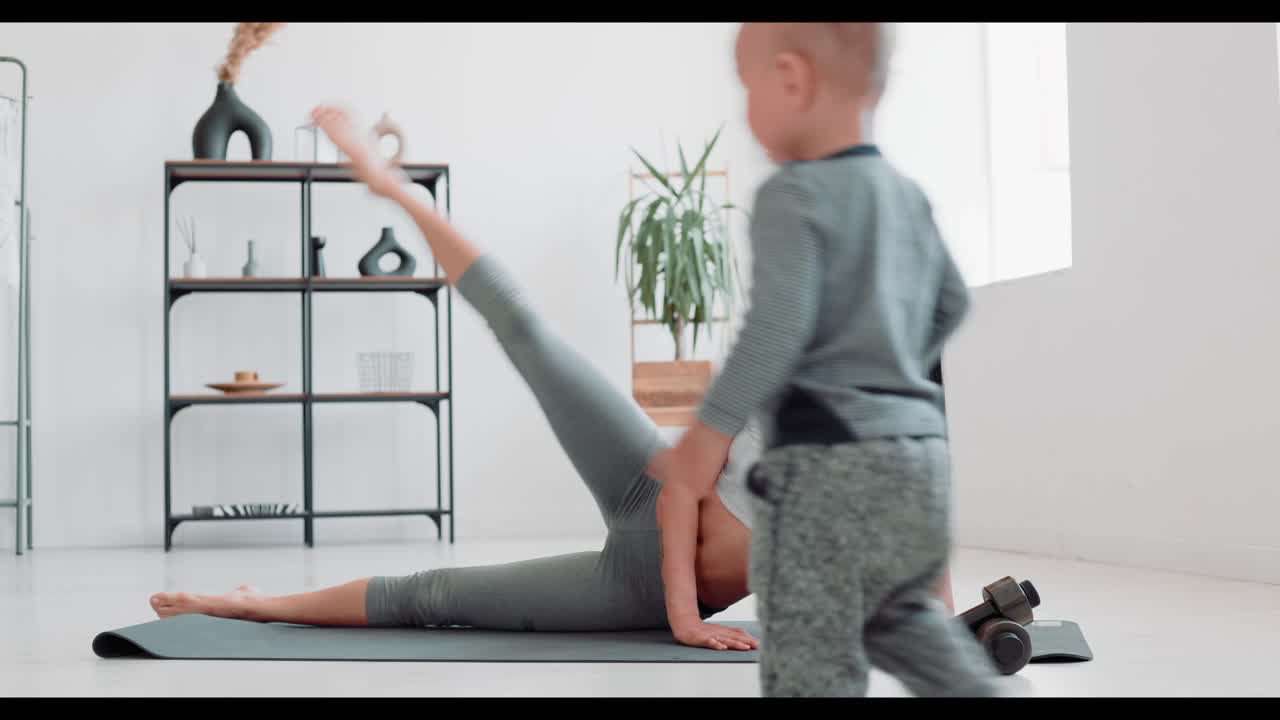 Woman exercising at home with her baby