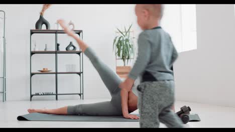 woman exercising at home with her baby