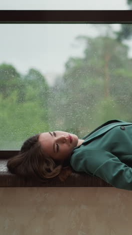 worn-out lady entrepreneur settles on windowsill. businesswoman craves moment of stillness among office chaos. quiet sanctuary during bustling day