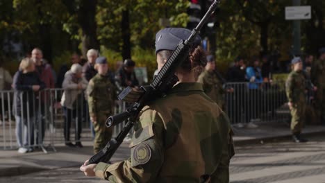 female soldier standing on karl johan during military parade