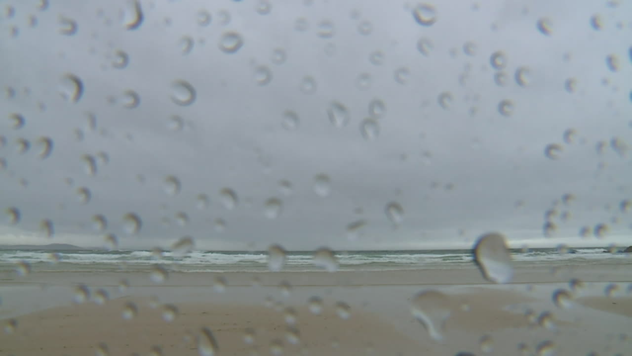 Rainy Beach View Through a Window