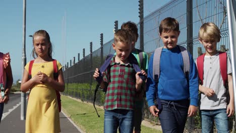 group of kids walking on the road