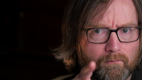 bearded man changing his expression from doubting to being surprised, close up shot