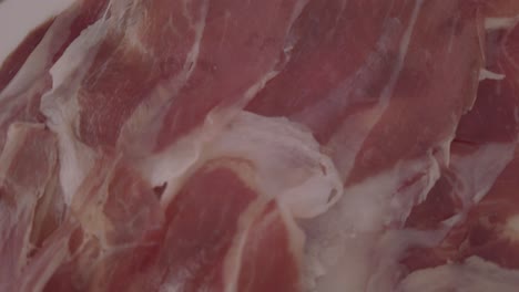 Thinly-Sliced-Spanish-Iberian-Ham,-Jamon-Iberico,-Close-Up-Detail-Shot