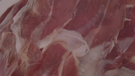 thinly sliced spanish iberian ham, jamon iberico, close up detail shot