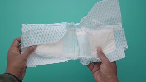 open baby diaper in hands