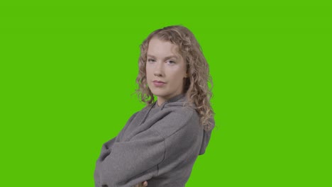 studio portrait of young woman with attitude against green screen 2