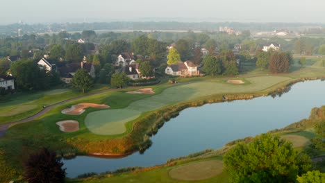 country club golf course homes with view of greens and water hazard pond