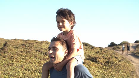 papá cargando al hijo, cargando al niño en los hombros