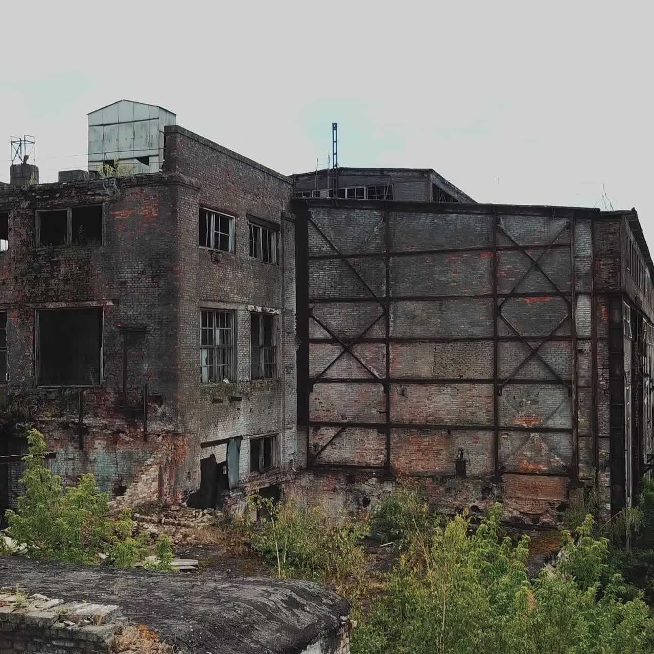 Aerial view from the air to an abandoned factory. Old industrial building for demolition.