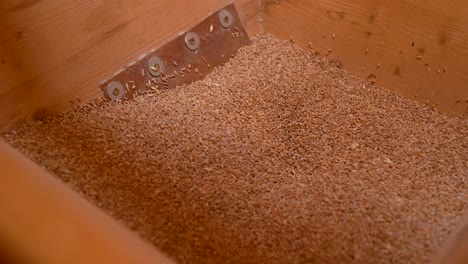 slow panning shot looking into box of sawdust and wood shavings collected during woodworking project