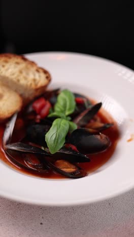 delicious mussels in red sauce with toasted bread