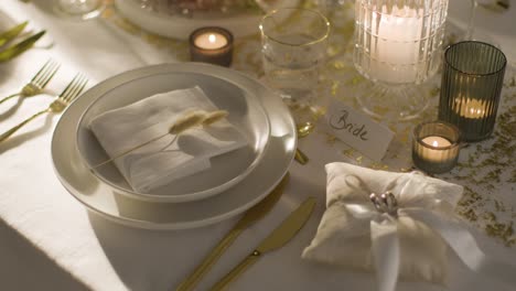 table set for meal at wedding reception with place card for bride and rings 1