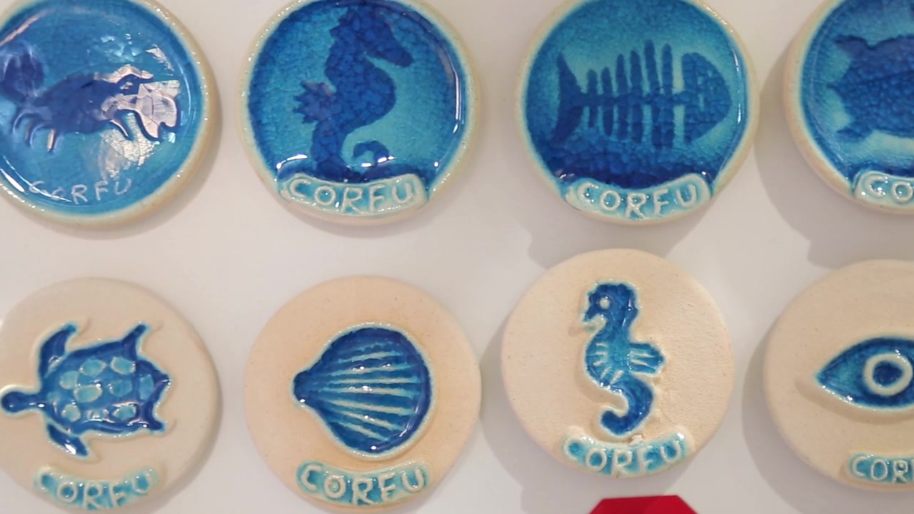 Slow Tracking Shot of Authentic Greek Handmade Ceramic Souvenir Magnets Featuring Sea Life in a Corfu Gift Shop, Greece.