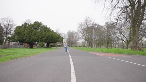 a young girl running and jumping at the park