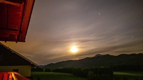 Alpine-sunset-timelapse:-sun-sets-with-subtle-halo-and-low-stratus-clouds-drifting-past