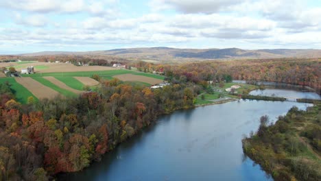 Rolling-hills-and-farm-field-along-river-lake-in-Lancaster-County-PA,-USA