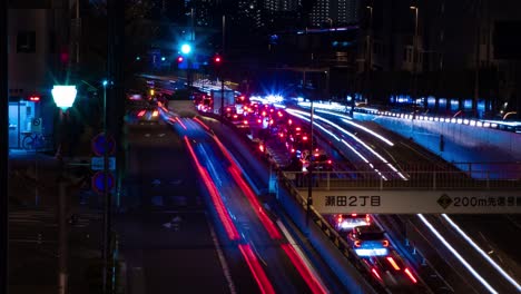 a night timelapse of the traffic jam at the city street in tokyo long shot