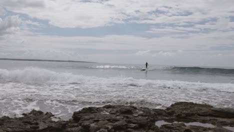 Surfer-On-Rolling-Sea-Waves-Against-Cloudy-Sky-In-Sardinia,-Island-Of-Italy