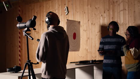 person analyzing targets shot using magnifying lens during firearm practice