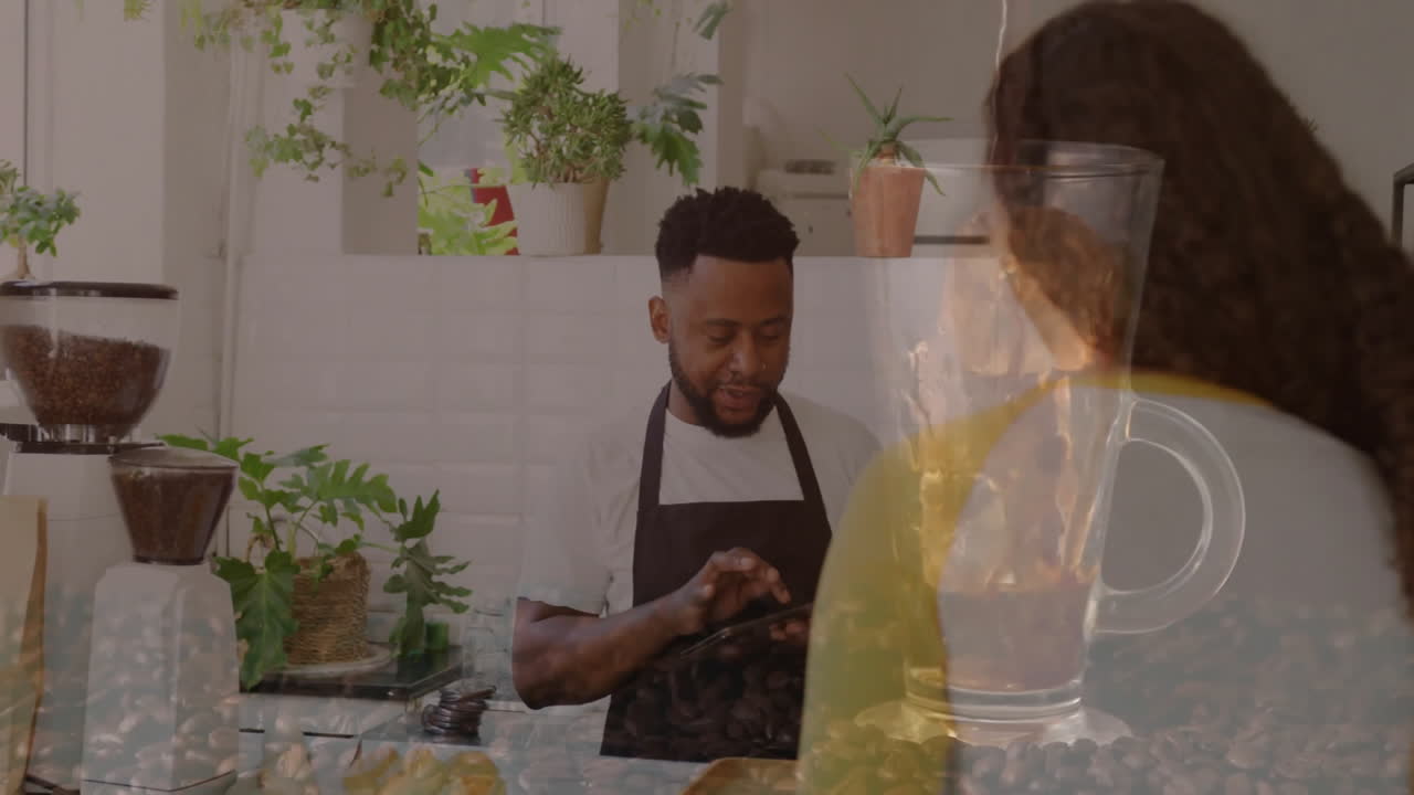 Barista presenting tablet interface to customer at café counter, showing animated coffee bean icons