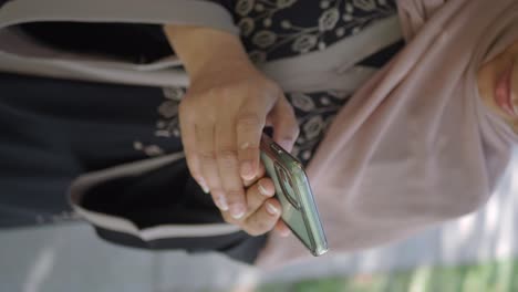 close-up of a person holding and using a smartphone