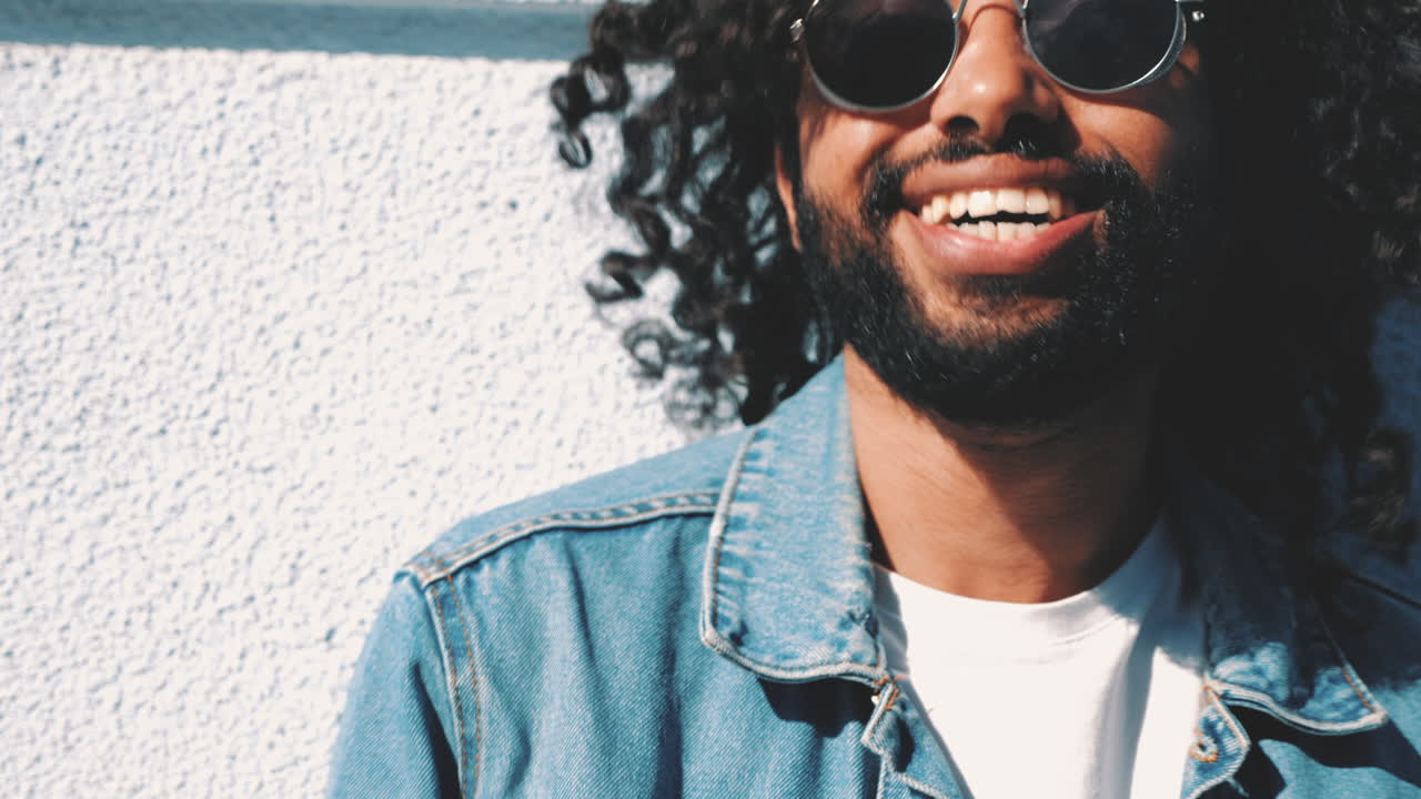 Smiling Man with Curly Hair and Sunglasses