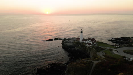 beautiful aerial shot of the portland headlight lighthouse overlooking the sea in portland, maine