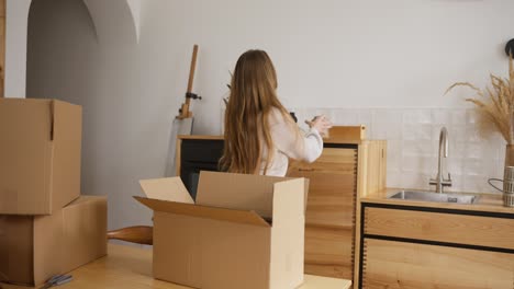 woman packing boxes in a kitchen