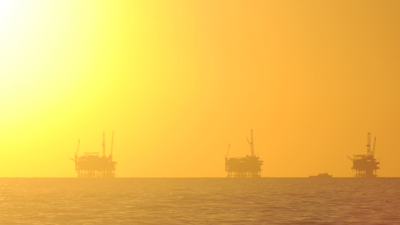 산타바바라 채널 캘리포니아 1에 있는 3개의 석유 플랫폼 뒤에서 해가 지는 낮부터 밤까지의 시간 경과