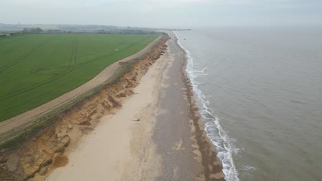 forward aerial shot of kessingland beach on a beautiful day in suffolk, england