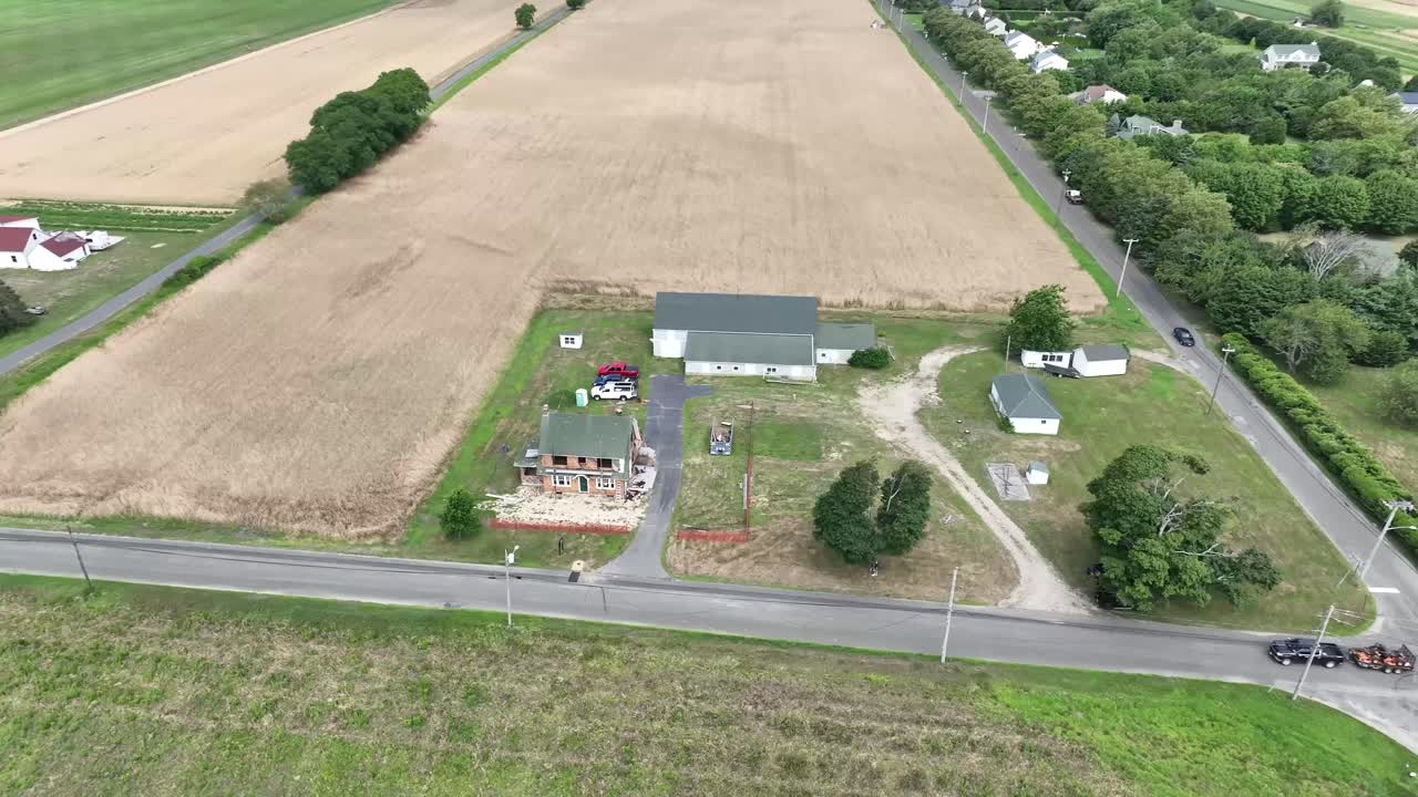 Drone flying over a farmhouse in long island with vineyards next doors