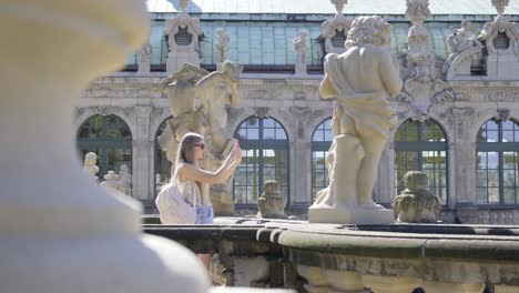 woman taking photo at zwinger palace in dresden
